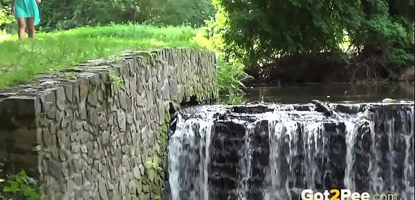  Sexy babe pees near a waterfall